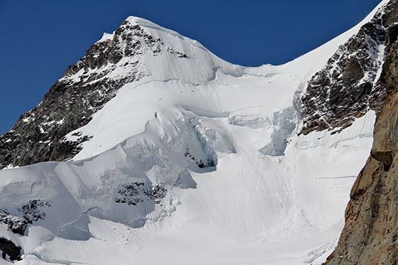 Climbers going up the Jungfrau 
 The human silhouettes provide a sense of the scale