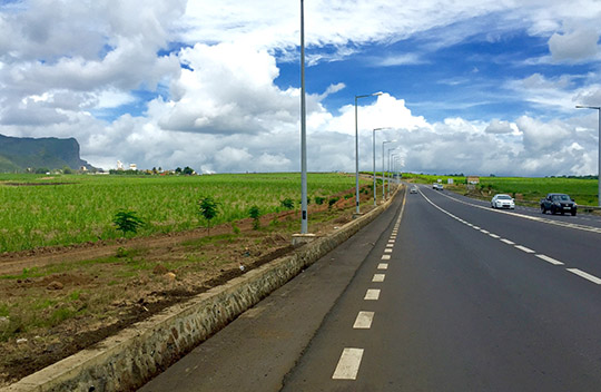 In 2015 the road is now wide, smooth and comfortable 
 The bougainvillea trees are gone but some young flamboyant trees replace them. I have to come back in 20 years to enjoy that. That will likely be quite beautiful then